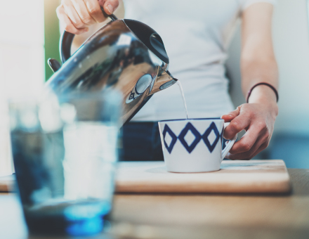 A woman pouring tea.