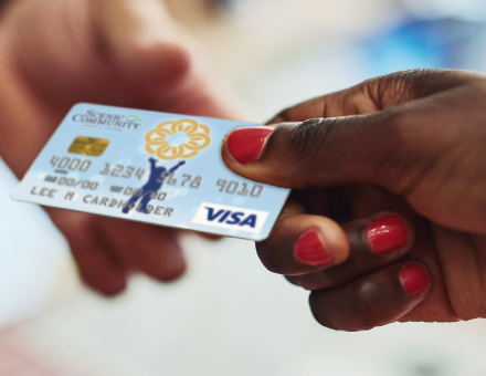 A woman using her SCCU Believe card.
