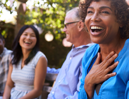 People laughing together outdoors.